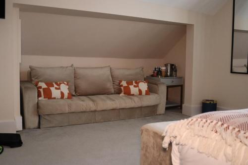 a living room with a couch with pillows on it at The Psalter in Sheffield