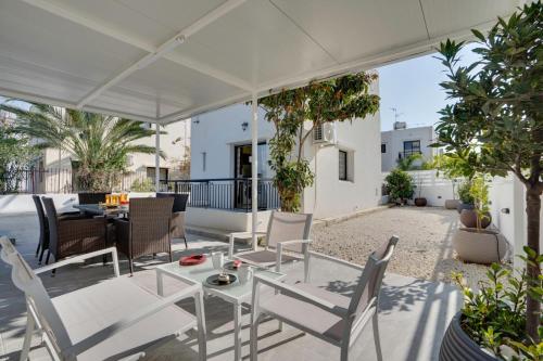 a patio with a table and chairs on a roof at Moments Together Villa in Voroklini
