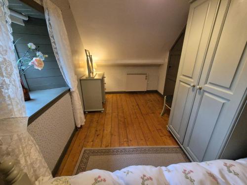 an attic room with a door and a wooden floor at O'Neill's Self Catering Cottage- close to Cashel in Tipperary