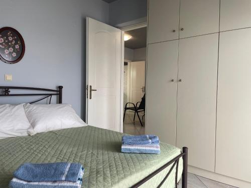 a bedroom with a bed with two towels on it at Maria's Beach House in Karfas