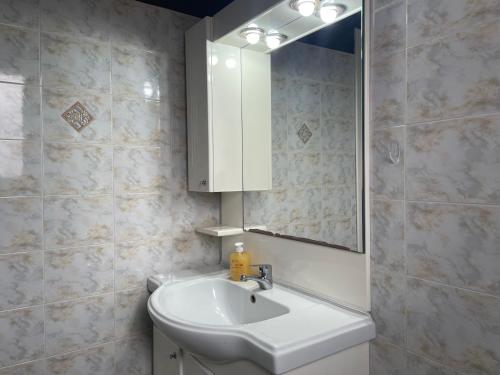 a bathroom with a sink and a mirror at Maria's Beach House in Karfas