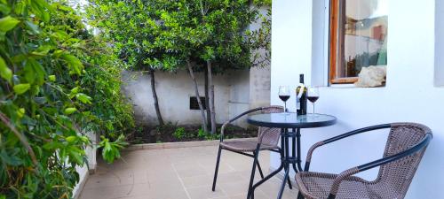 a table and chairs on a patio with a window at Summerbreath Apartments in Ahtopol