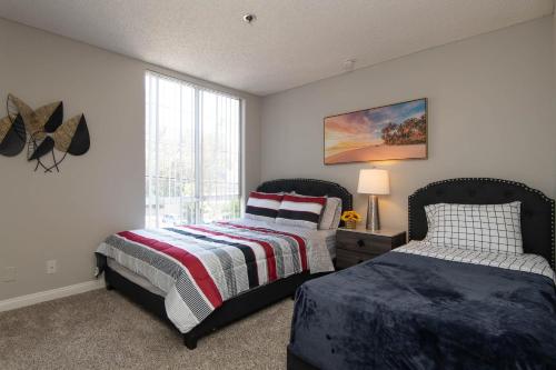 a bedroom with two beds and a window at Modern Escape in Hollywood with Rooftop & City Views in Los Angeles