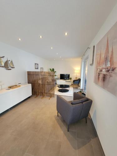 a living room with a couch and a table at FeWo Bodanblick in Bodman-Ludwigshafen