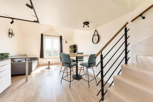 - un salon avec des escaliers, une table et des chaises dans l'établissement Résidence Port du Crouesty - maeva Home - Appartement bord de mer 4 pièces 5 personnes - Prestige - super Home MAE-9403, à Arzon