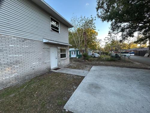 a house with a driveway next to a building at The Sunshine State Midpoint in Seffner
