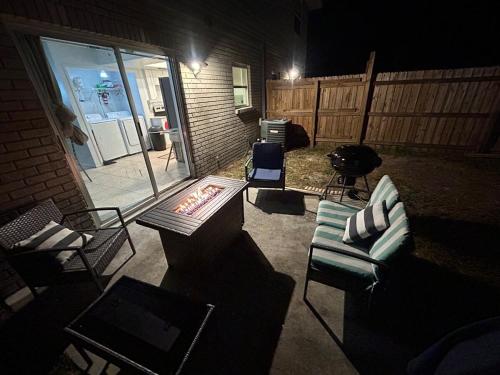 a patio with couches and a fire pit at night at The Sunshine State Midpoint in Seffner