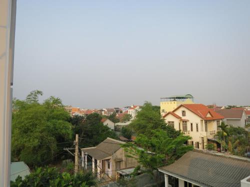 a view of a city with houses and trees at Fireworks Homestay in Hoi An