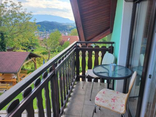 a balcony with a table and chairs and a view at Apartma Angelika in Mozirje