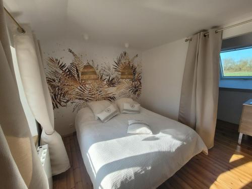 a small bedroom with a bed in a room at Maison de Coton Ty Koton in Plourivo