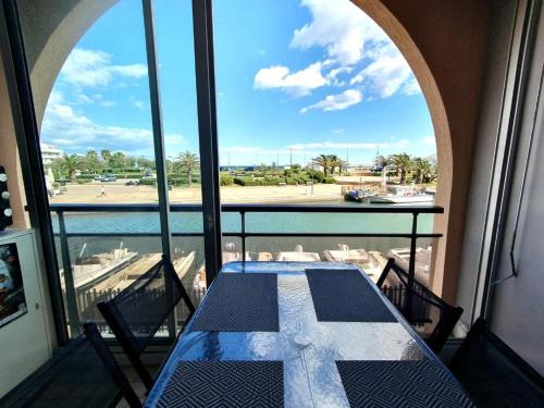a table on a balcony with a view of the water at Charmant 2 pièces, Vue sur Mer - Proche Plage in Sète
