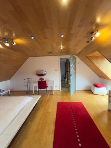 a bedroom with a large bed and a red rug at Elysium Estate Szekszárd in Szekszárd