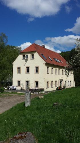 a large white building with a red roof at Holzwerk Oybin in Kurort Oybin