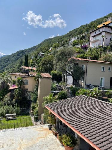 a group of houses with a mountain in the background at Appartamenti Ramarro in Ronco s/Ascona - Porto Ronco