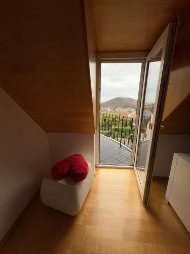 a room with a couch and a large window at Elysium Estate Szekszárd in Szekszárd