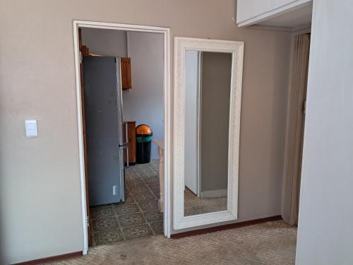 an empty room with a mirror and a closet at Hideaway in Roodepoort