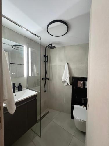 a bathroom with a sink and a toilet and a mirror at Selena Boutique in Neos Marmaras