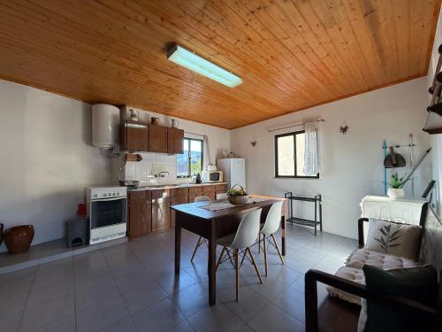 a kitchen with a table and a dining room at Casa dos Antunes in Terras de Bouro