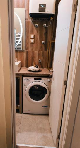 a washing machine in a bathroom with a sink at Marigold Premium in Novi Sad
