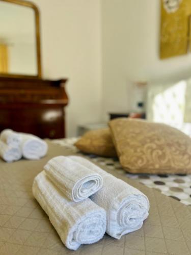 two towels sitting on top of a bed at Blue Marine Affitta Camere in Porto Cesareo