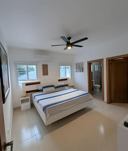 una camera da letto con un letto e un ventilatore a soffitto di Atlantic 9, Apartamento cerca de playa. a Sabana Grande
