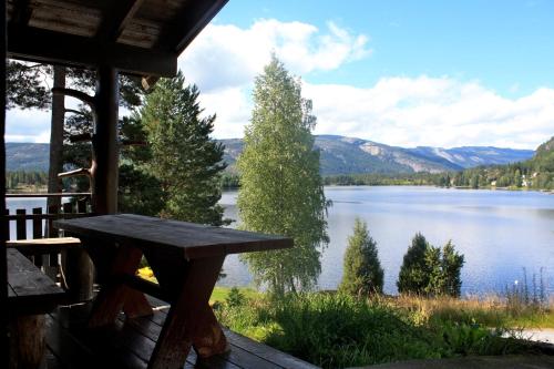 a view of a lake from the porch of a cabin at Nedre Strand Hytteutleie in Vradal