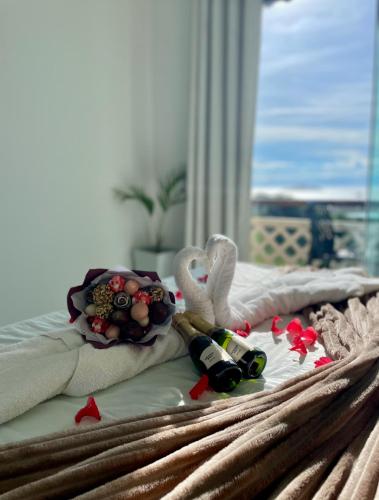 a bed with a pile of towels and toys on it at Pousada Bella vista in Búzios