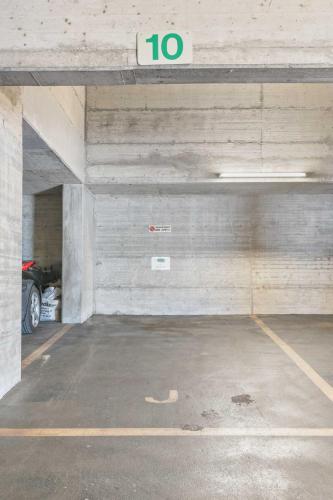 an empty parking garage with a speed limit sign in it at Residenza Paradiso App 1000 in Orselina