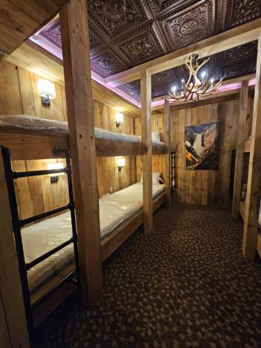 a room with two bunk beds and a ceiling at Eaglescape Suites and Event Center in Miles City