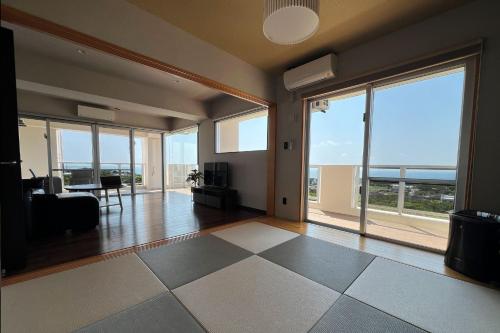 an empty living room with a view of the ocean at Hotel Okinawa Muto - Vacation STAY 24149v in Nanjo