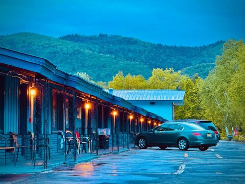 a car parked in a parking lot next to a building at Travelodge by Wyndham Lake George NY in Lake George