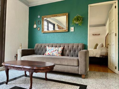 a living room with a couch and a mirror at Senda Stays Condesa in Mexico City