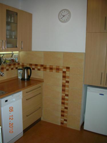 a kitchen with a counter and a clock on the wall at Chalupa SVRATKA in Moravská Svratka