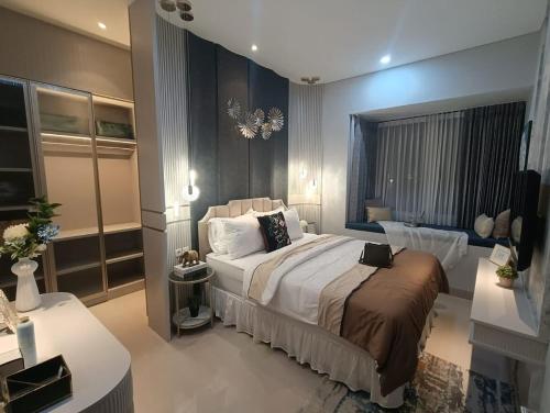 a bedroom with a large bed in a room at JessAble Home Stay in Manado