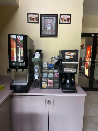 a counter with a television on top of a refrigerator at Executive Inn in Zanesville