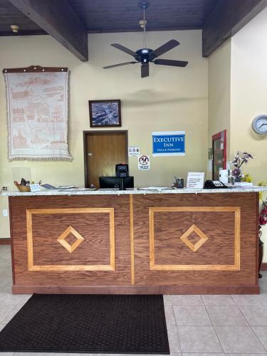 an office with a reception desk with a ceiling fan at Executive Inn in Zanesville