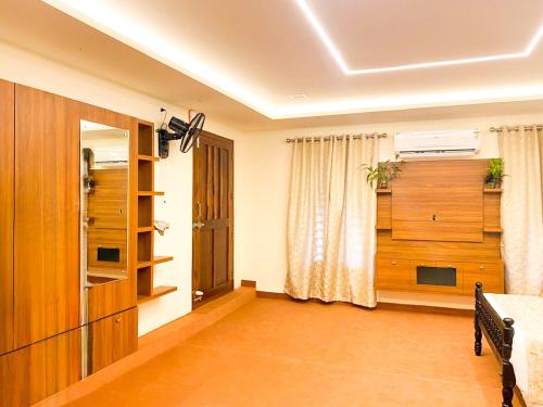 a living room with a bed and a window at JoeVilla Homestay Near Kottiyoor in Kelakam
