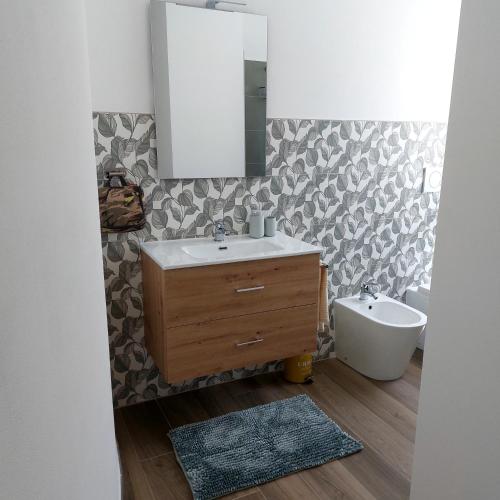 a bathroom with a sink and a mirror at Suite Valmarecchia in Pietracuta