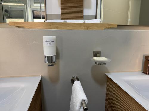 a bathroom with a white sink and a towel at Mahesars Home in Gevelsberg
