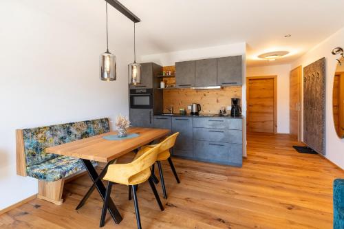 a kitchen and dining room with a wooden table and chairs at Haus Alpenblick in St. Wolfgang