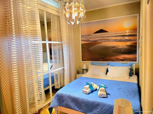 a bedroom with a bed with two pairs of shoes on it at Golden Sea View -Thasos House in Skala Potamias