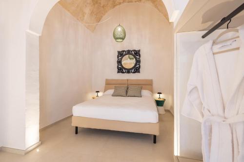a bedroom with a bed in a white room at Casa Annunziata Guest House in Ruffano