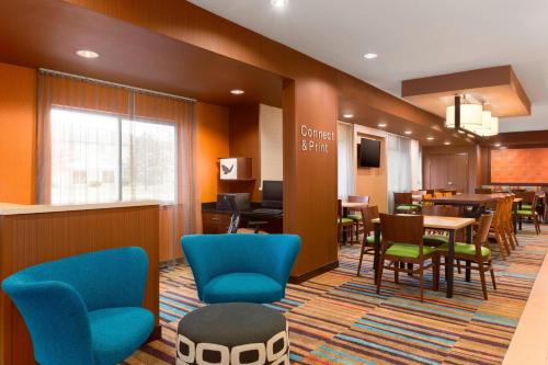 a waiting area with chairs and tables and a waiting room at Fairfield Inn & Suites by Marriott Mankato in Mankato