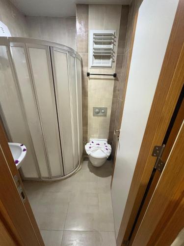 a small bathroom with a toilet and a window at Nativo Otel in Antalya