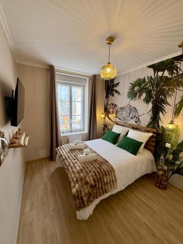une chambre avec un grand lit avec des oreillers verts dans l'établissement L Écrin Rémois, à Reims