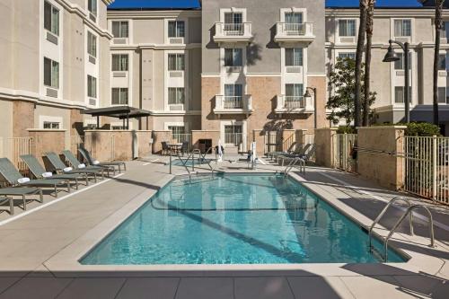 a swimming pool on the roof of a building at TownePlace Suites by Marriott Ontario Airport in Rancho Cucamonga