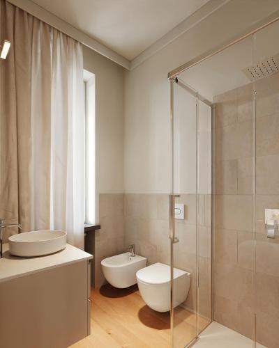 a bathroom with a sink and a toilet and a shower at Casa Visconti Milano in Milan