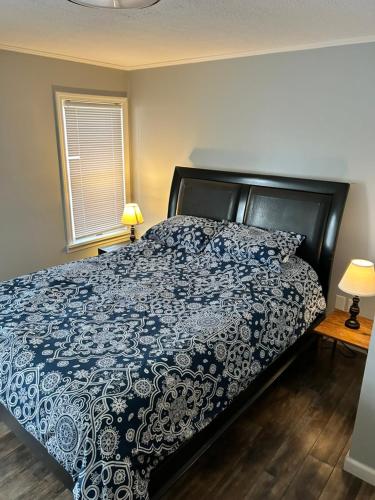 a bedroom with a bed with a blue and white comforter at Clayton Dahlia Retreat in Clayton