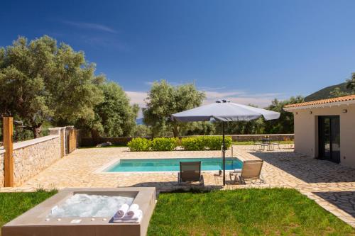 a villa with a swimming pool and an umbrella at Lefkolia Retreat in Sivota