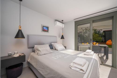 a bedroom with a bed with towels on it at Argostoli Haven - Luxury House in Argostoli